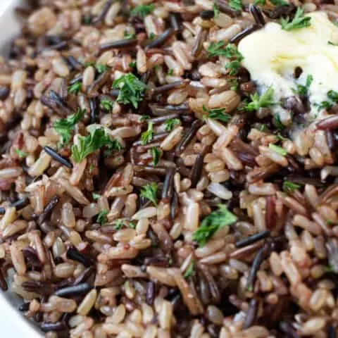Closeup of wild blend rice with a pat of butter on top.