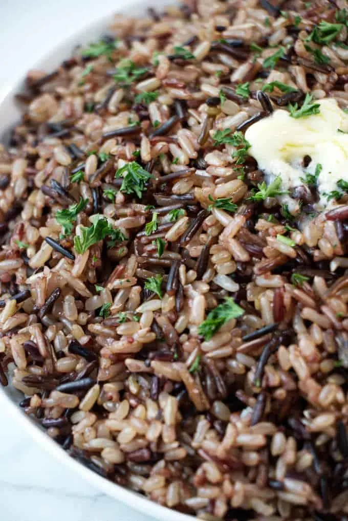 Closeup of wild blend rice with a pat of butter on top.