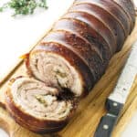 Porchetta on cutting board with knife