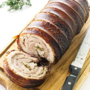 Porchetta on cutting board with knife