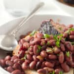 A serving of red beans and ham on a slice of sourdough bread.