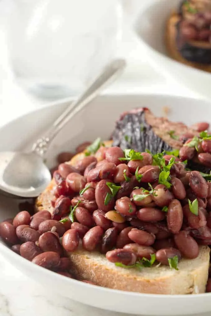 A serving of red beans and ham on a slice of sourdough bread.