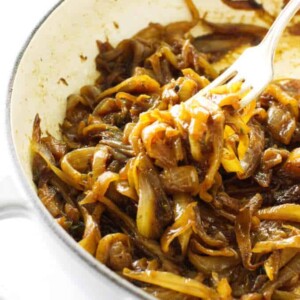 A fork picking up some caramelized onions.