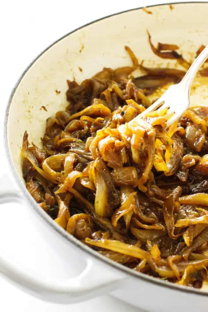 A fork picking up some caramelized onions.