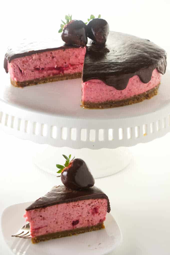 A chocolate covered strawberry cheesecake with chocolate covered strawberries on top.