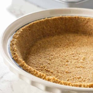 Graham cracker crust in a pie plate.