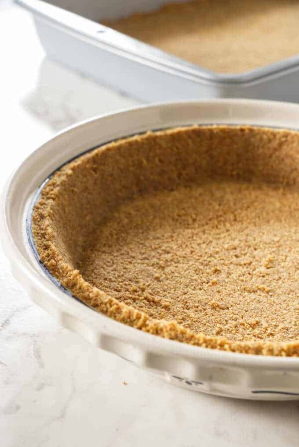 Graham cracker crust in a pie plate.