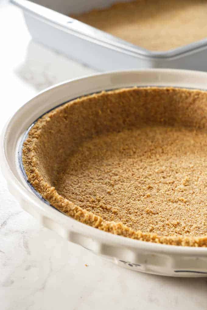 Graham cracker crust in a pie plate.