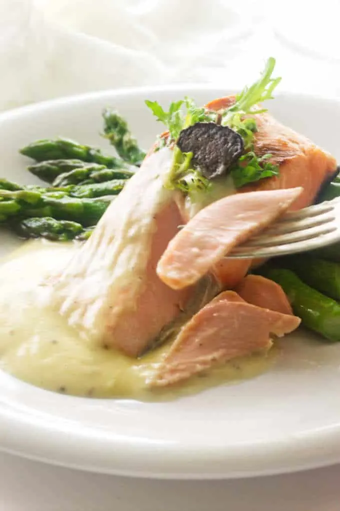 asparagus, salmon and Beurre Blanc sauce, salmon bite on fork