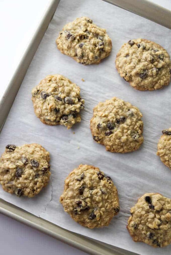 A baking sheet of warm oatmeal raisin cookies.