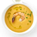 Overhead view of a bowl of creamy shrimp bisque and spoon