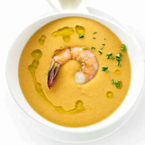 Overhead view of a bowl of creamy shrimp bisque and spoon