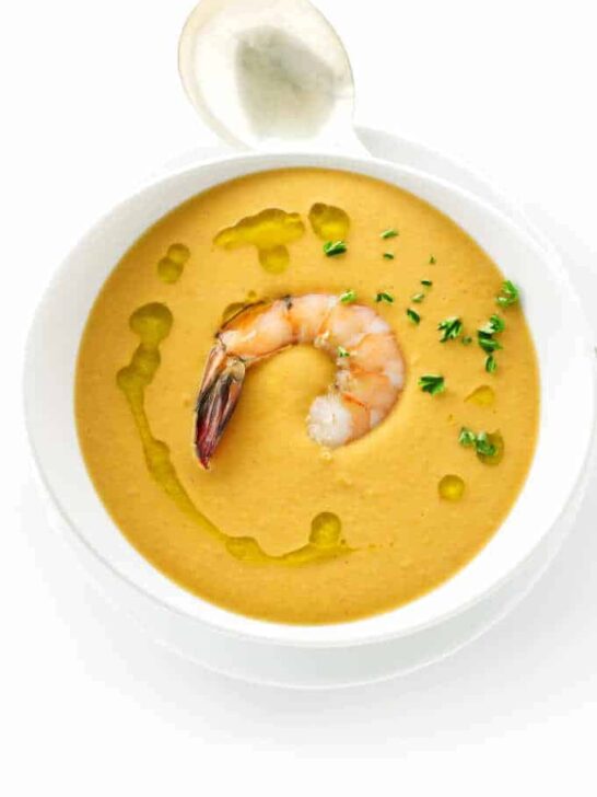 Overhead view of a bowl of creamy shrimp bisque and spoon