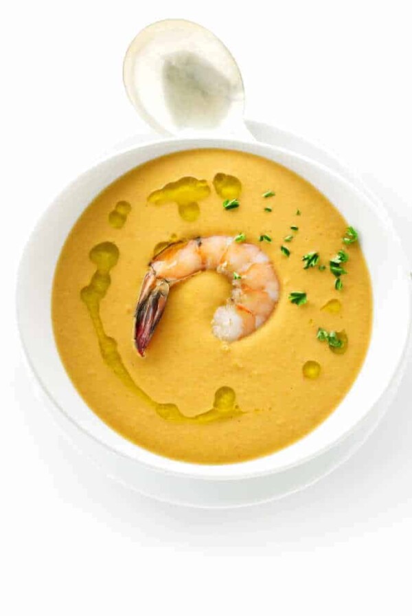 Overhead view of a bowl of creamy shrimp bisque and spoon