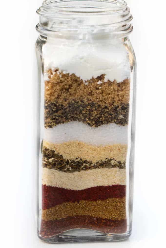 10 spices layered in a jar for taco seasoning.