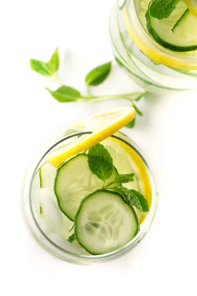 An overhead photo of a glass of cucumber lemon water.