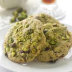 A closeup of pistachio cherry cookies that have dried cherries.