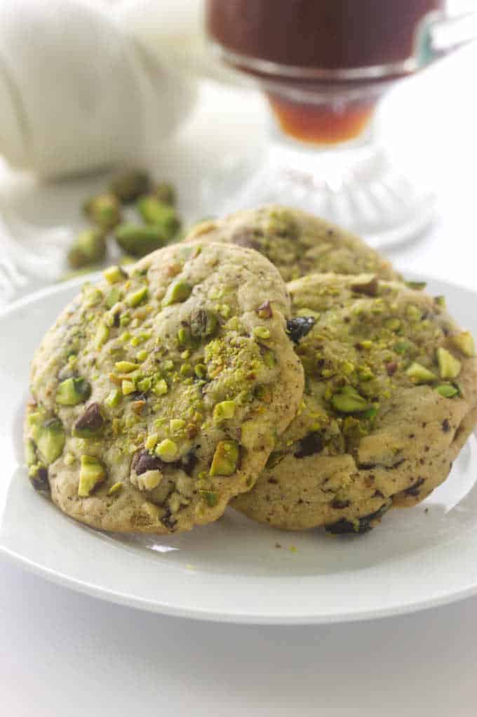 A closeup of pistachio cherry cookies that have dried cherries.