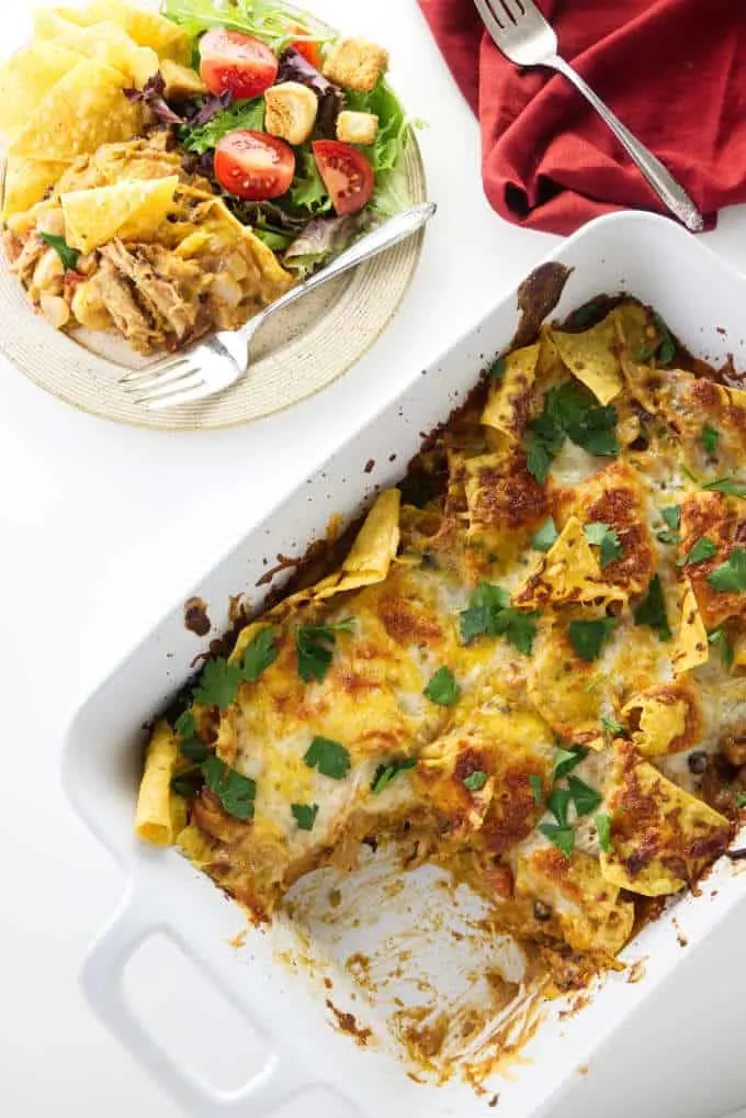 A casserole dish with tortilla chip casserole in it.