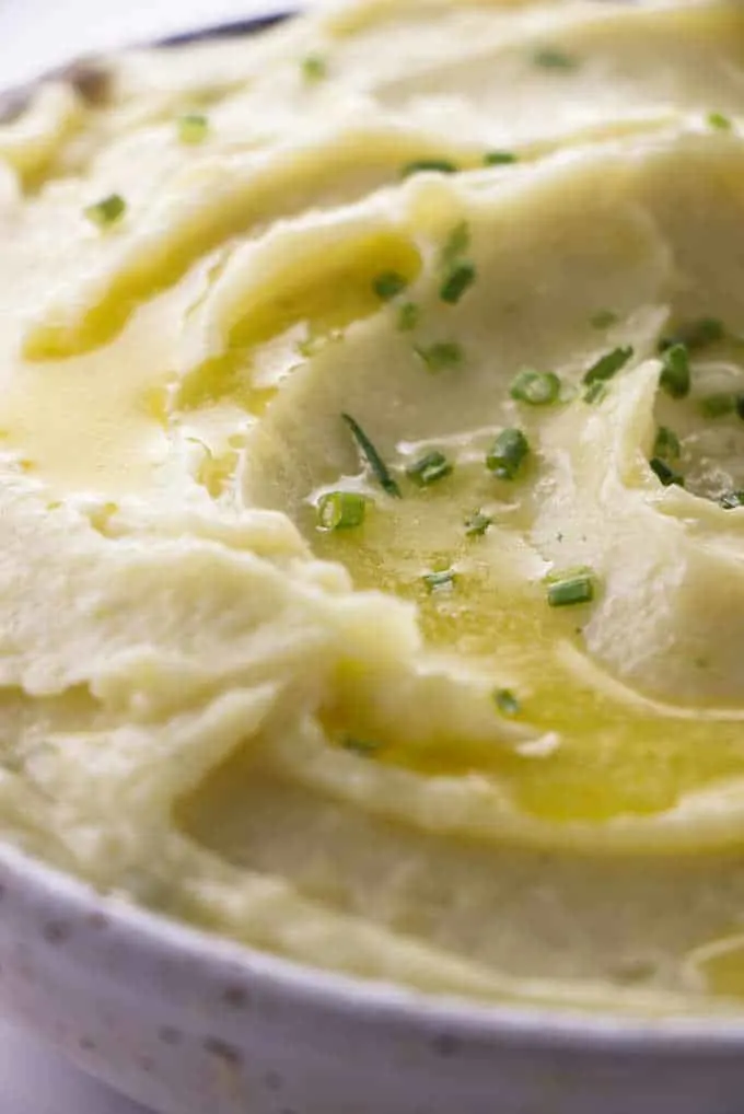 Buttermilk ranch mashed potatoes with melted butter and chives on top.