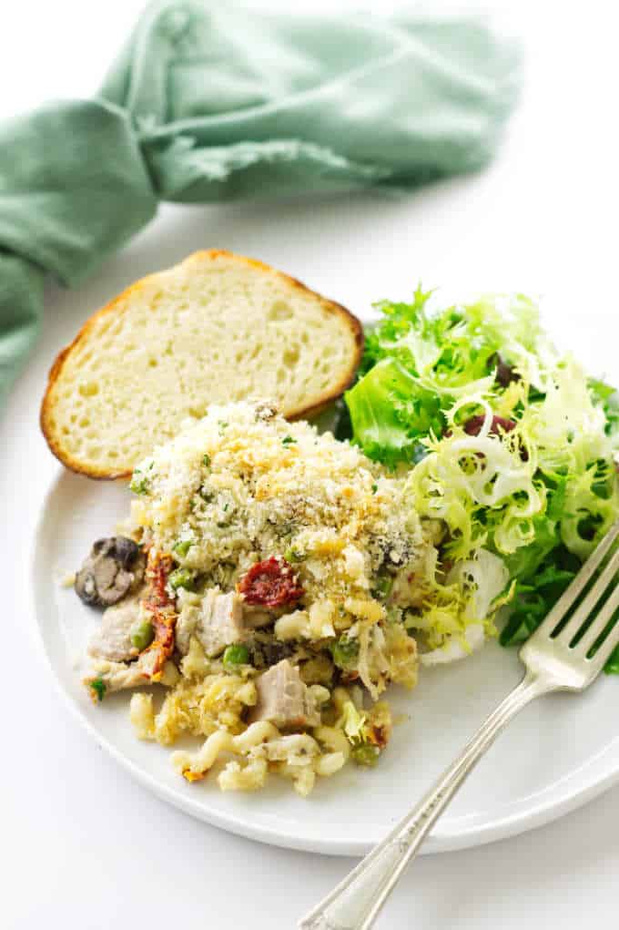 Serving of turkey Tetrazzini with salad and bread.