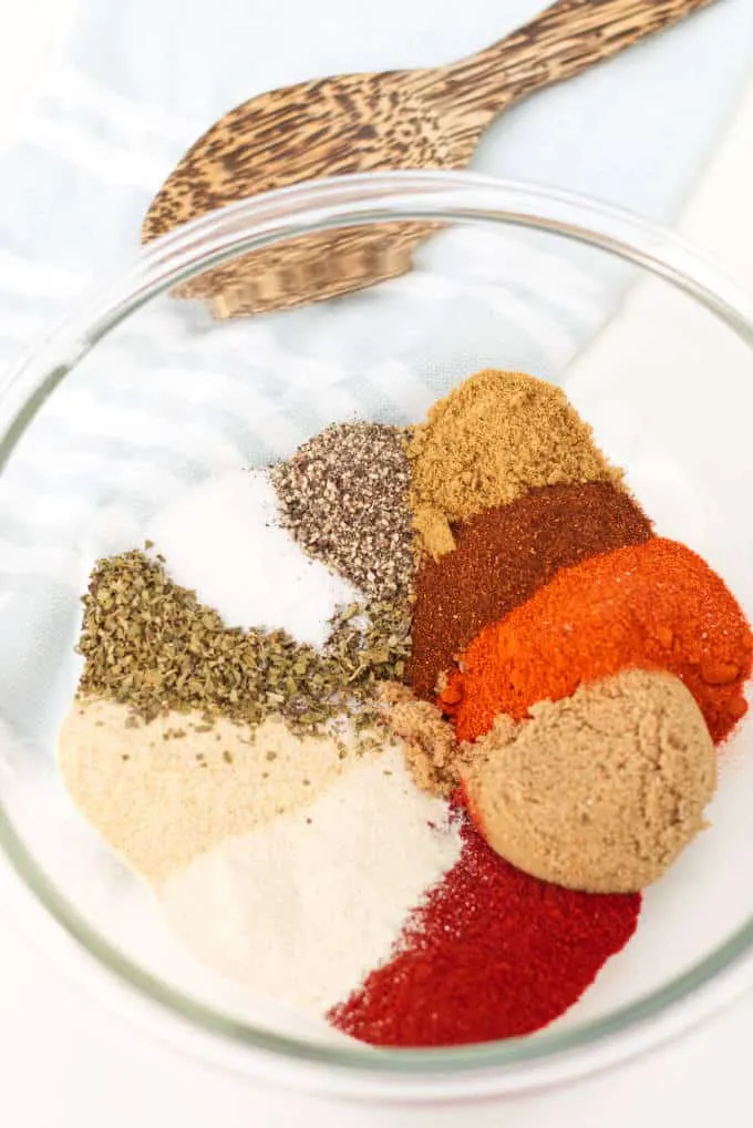 Several spices in a bowl ready to be mixed for a barbeque seasoning.