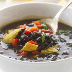 Overhead view of Chipotle Black Bean Soup, garnished with red bell pepper and scallions