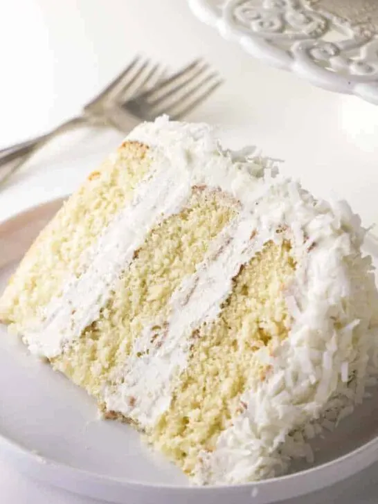 A single slice of coconut cake with coconut buttercream.