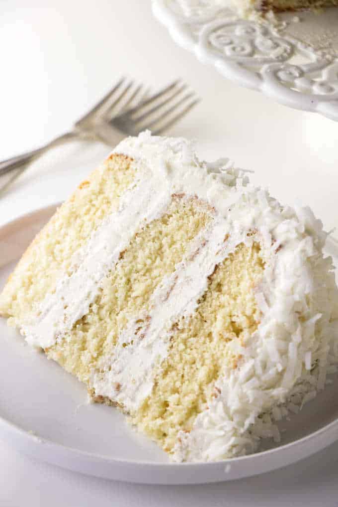 A single slice of coconut cake with coconut buttercream.