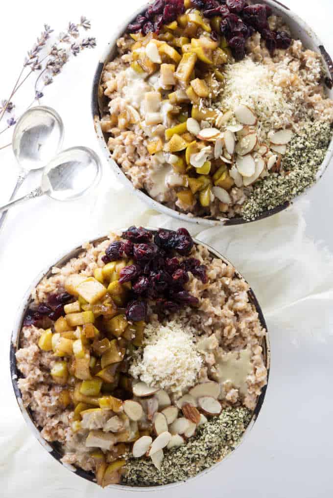 Two bowls of hot spelt cereal with toppings.