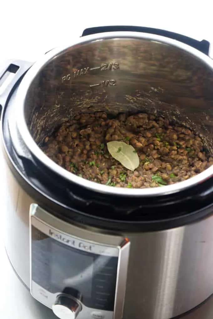 An instant pot with cooked lentils.