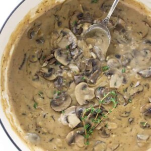 A skillet with mushroom marsala sauce inside.