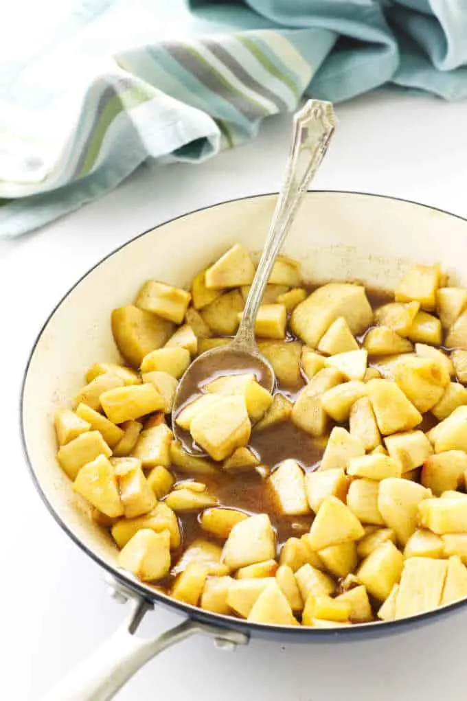 Skillet with spoon, apples brown sugar mixture