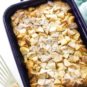 casserole of baked french toast and apples, dusted with confectioner's sugar