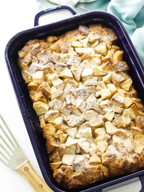 casserole of baked french toast and apples, dusted with confectioner's sugar