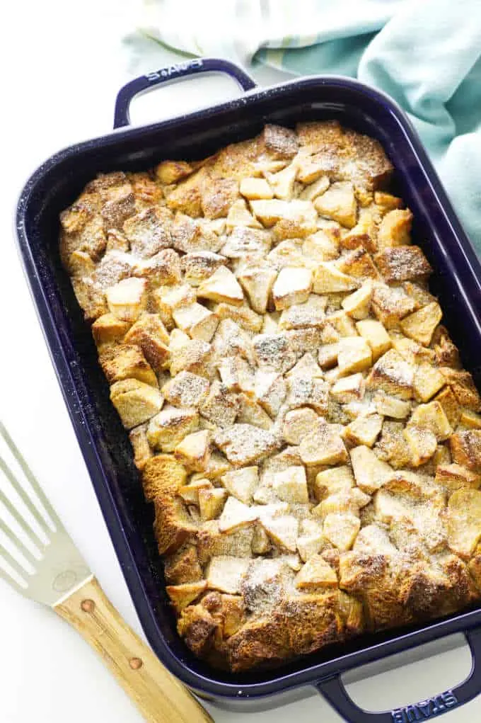 casserole of baked french toast and apples, dusted with confectioner's sugar