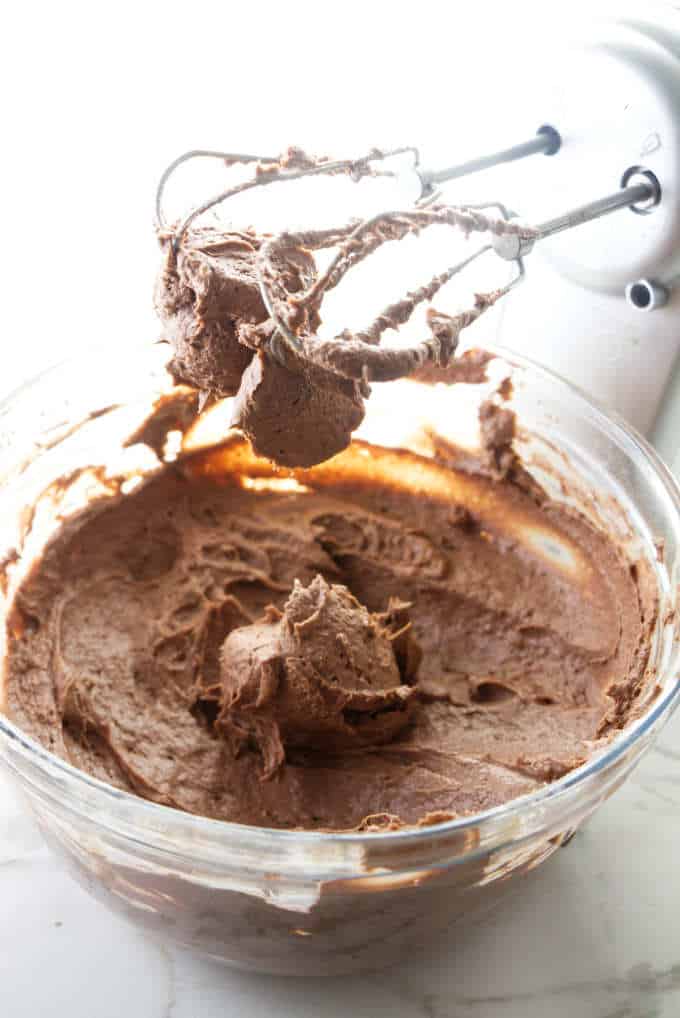 Chocolate filling for cake in a mixing bowl.