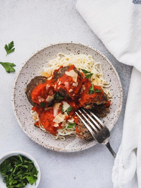 keto Italian meatballs on a plate with parsley on the side