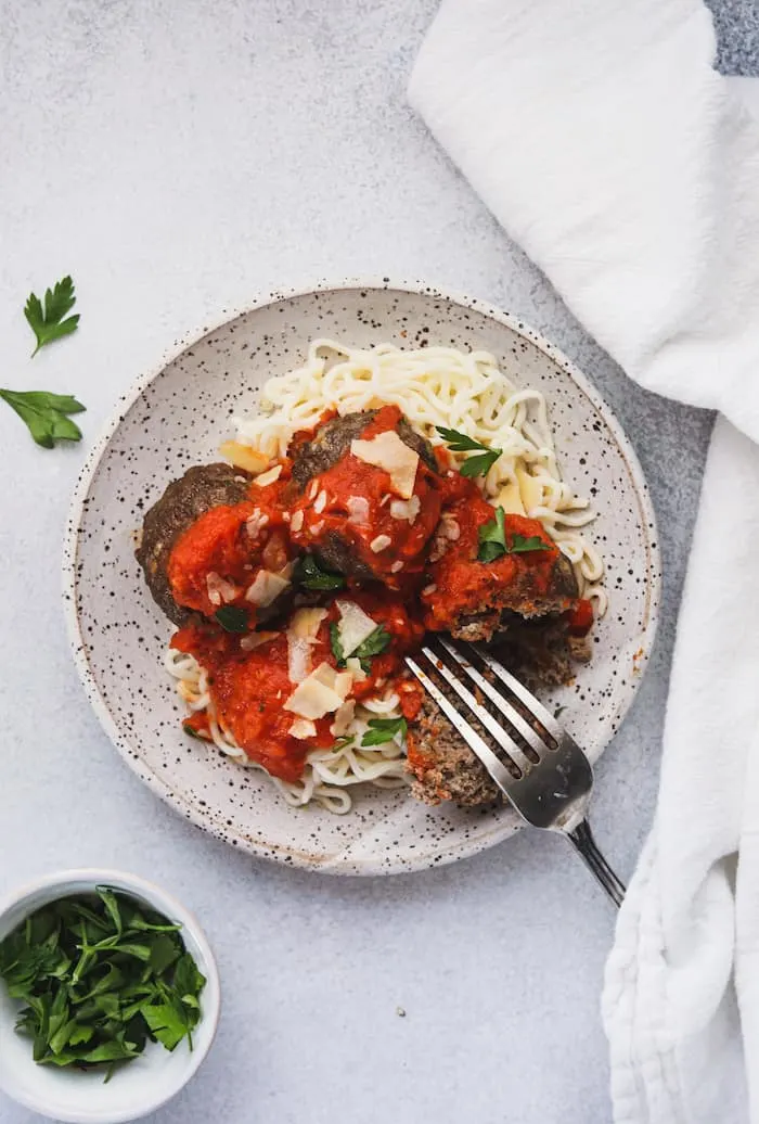 keto Italian meatballs on a plate with parsley on the side