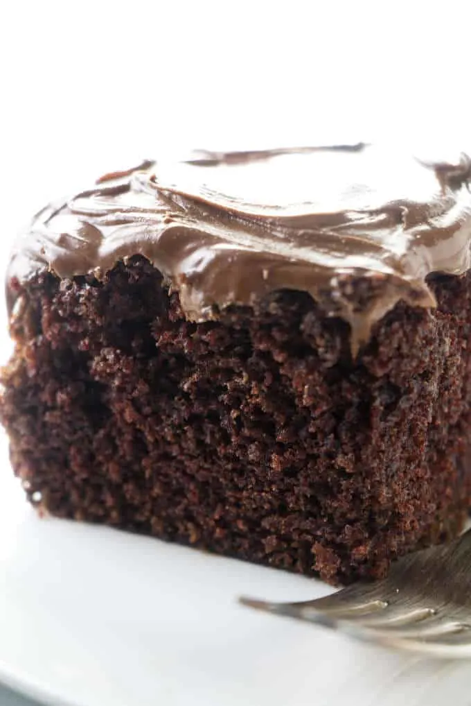 A slice of wacky chocolate cake with peanut butter ganache frosting.