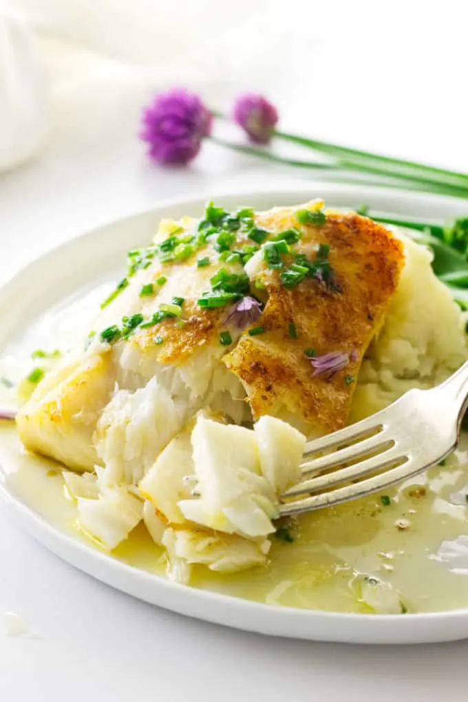 close up view of flaky cod on a fork