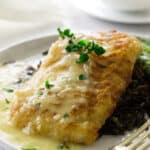 close up view of cod fillet, lemon-garlic sauce, wild rice