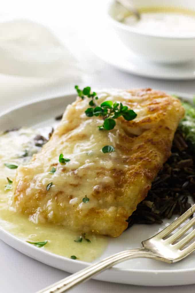 close up view of cod fillet, lemon-garlic sauce, wild rice