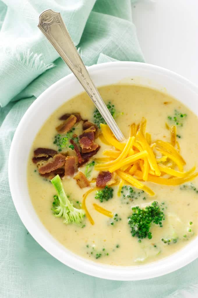 Overhead view of soup, garnished with broccoli, bacon and cheddar