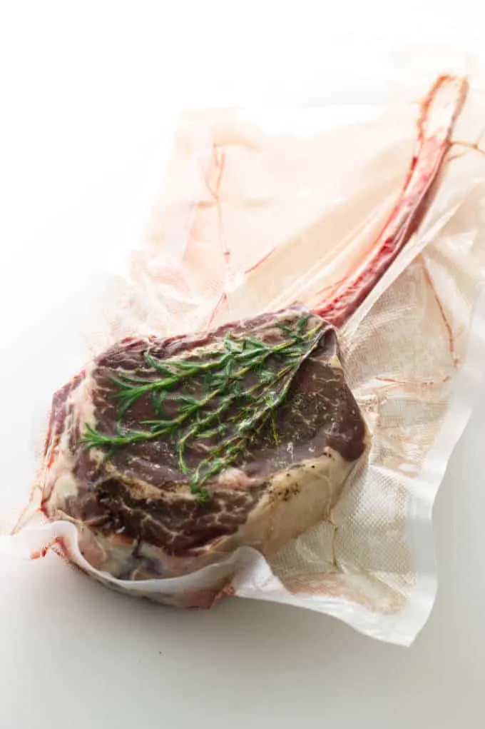 Tomahawk steak in a vacuum sealed bag.
