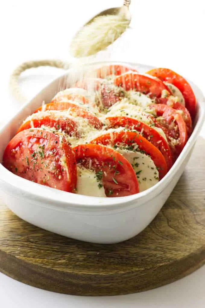 Sprinkling bread crumbs on the tomato casserole.