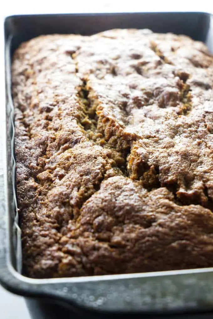 Banana bread fresh out of the oven and still in the bread pan.