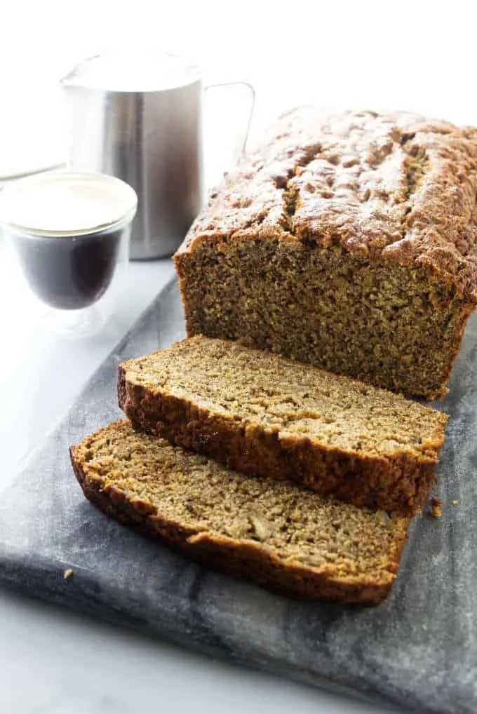 Spelt banana bread with a cup of espresso in the background