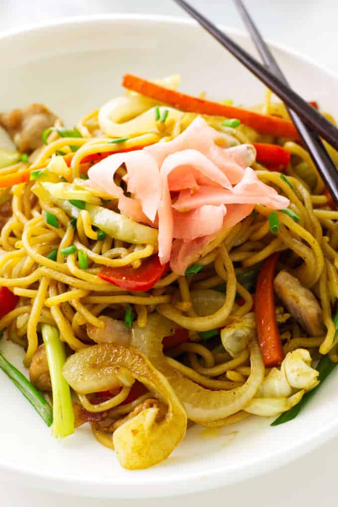 overhead view of pork yakisoba garnished with pickled ginger