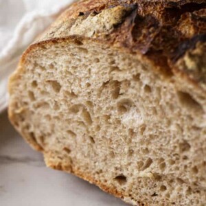 A sliced loaf of sourdough spelt bread.